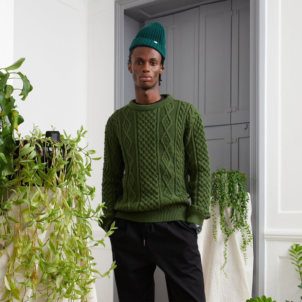 Model wearing the Conway Cable Knitwear - Men's Fisherman Jumper - Pitch Green